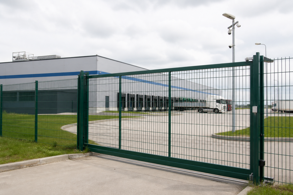 Welded mesh perimeter fence and sliding gate at a logistics facility